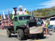 Thumb Nail view of the green Dodge Power Wagon, the un-Official truck of Constitution Week advertising the Constitution Week Event in Grand Lake, Colorado  with patriots throwing candy; click here to open a window with a larger picture.